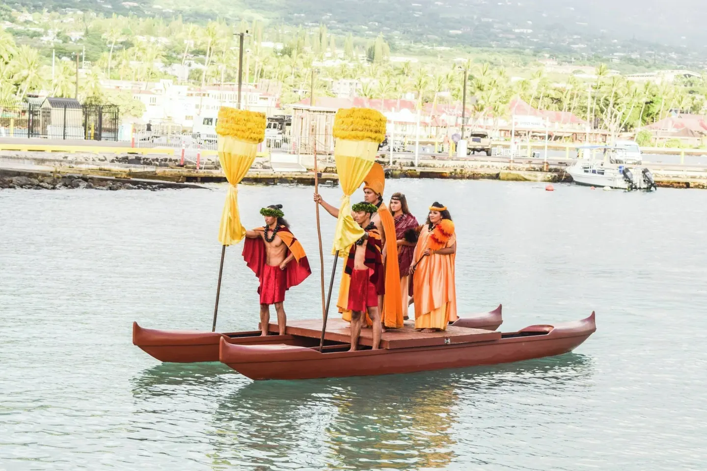 Performers on a double-hulled canoe offshore at Courtyard King Kamehameha's Kona Beach Hotel.