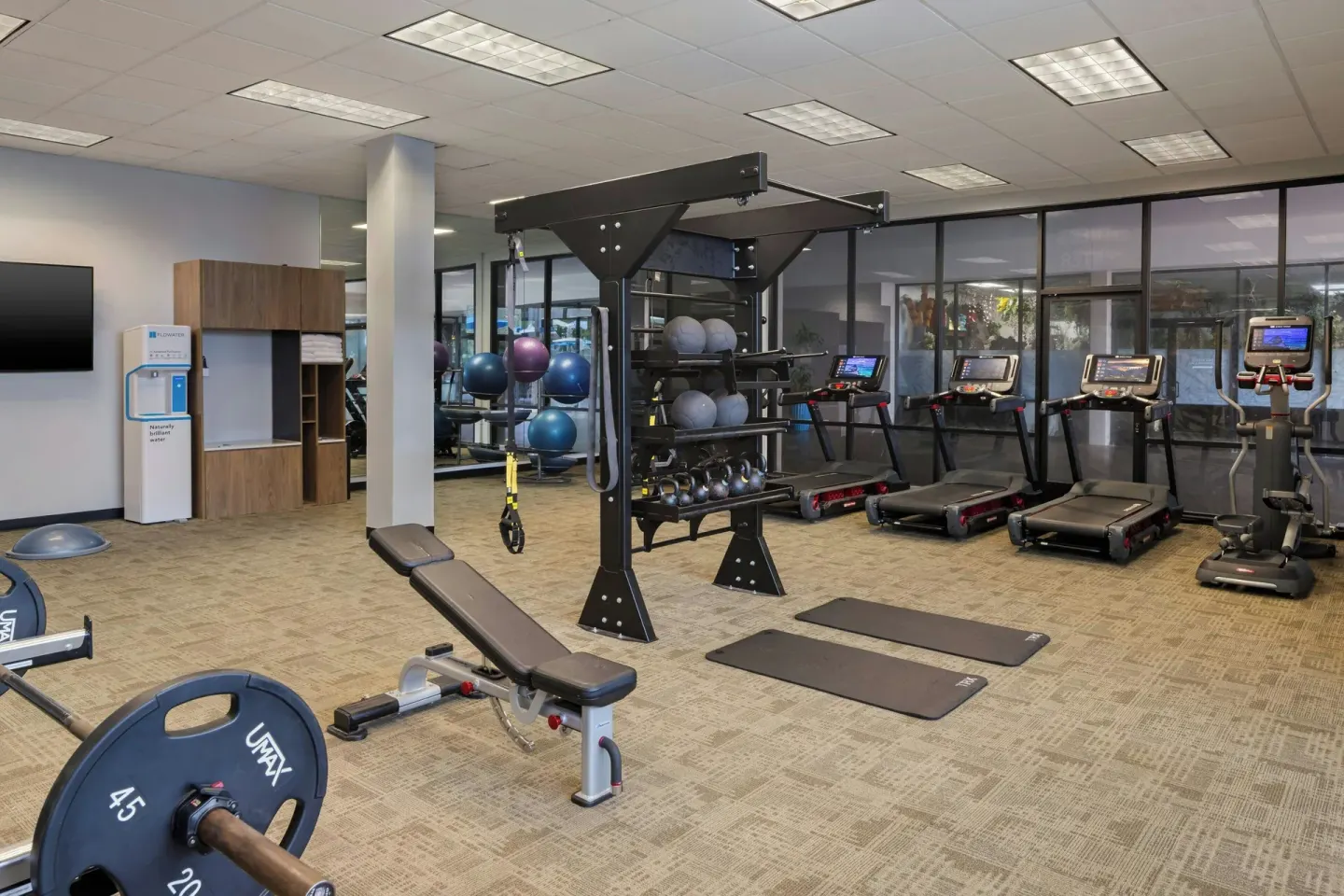 Fitness center weights and treadmills at Courtyard King Kamehameha's Kona Beach Hotel.