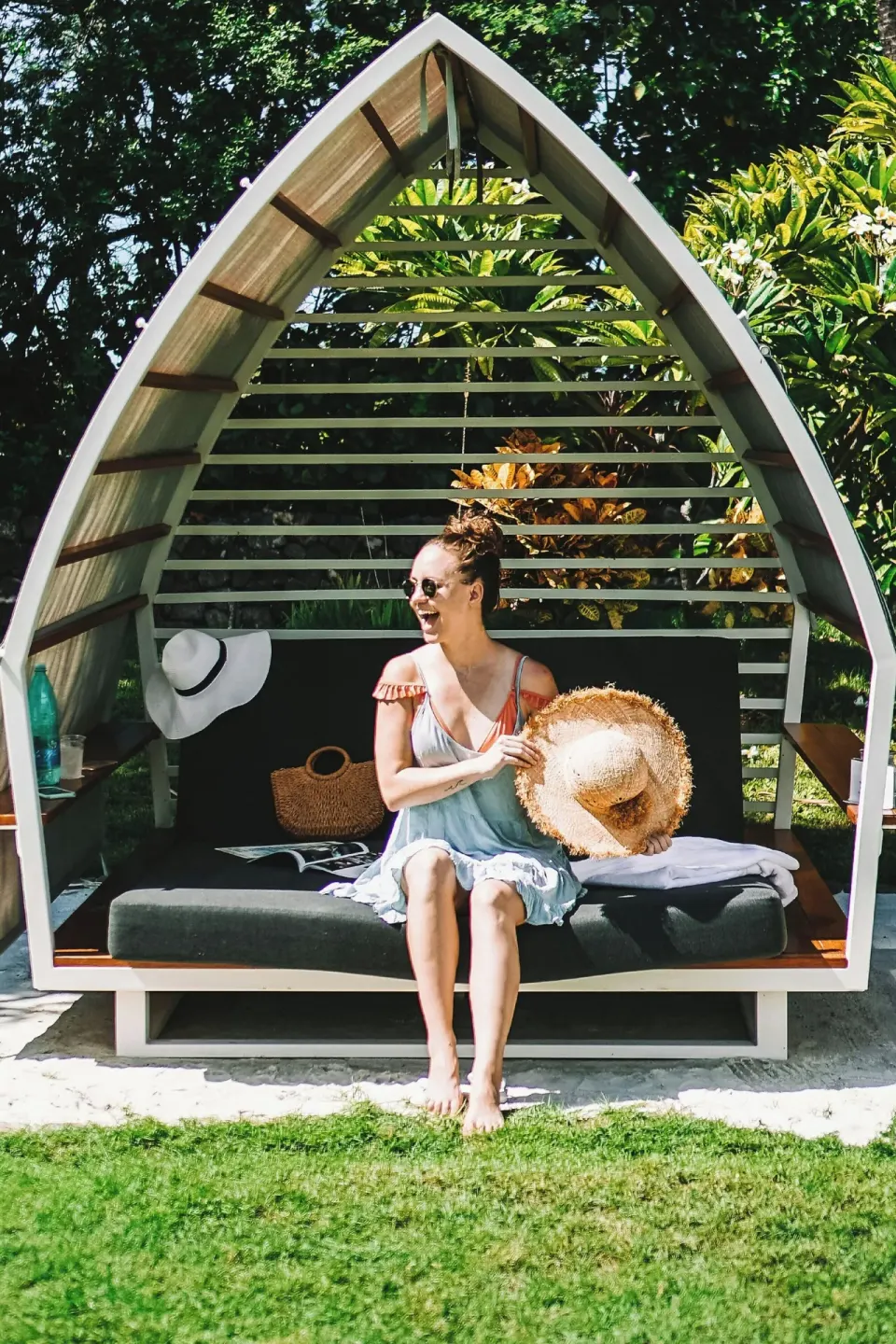 Garden cabana daybed with a seated guest at Courtyard King Kamehameha's Kona Beach Hotel.