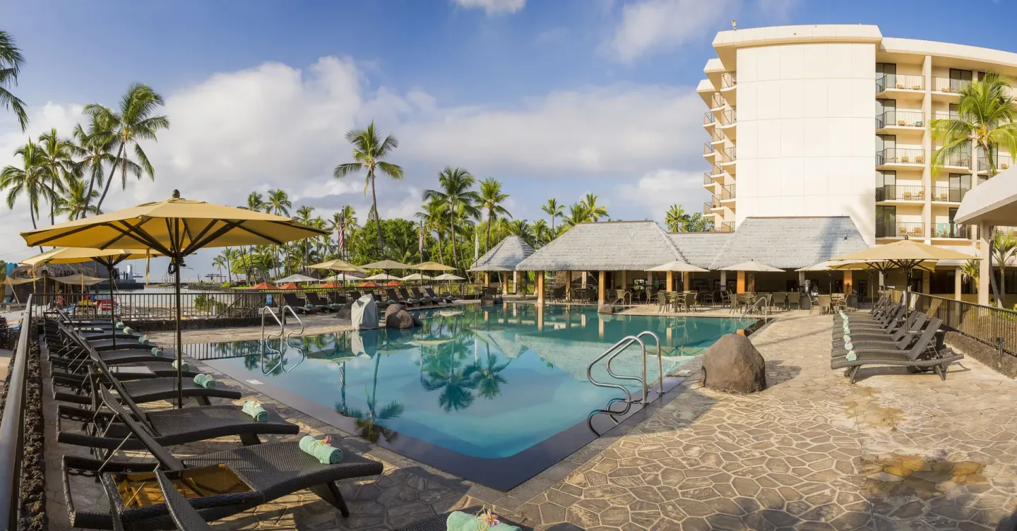 Wide pool deck with loungers at Courtyard King Kamehameha's Kona Beach Hotel.