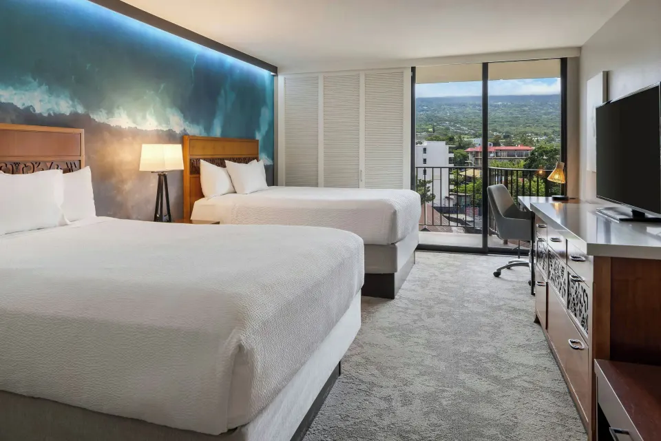 Two-bed guest room with balcony mountain view at Courtyard King Kamehameha's Kona Beach Hotel.