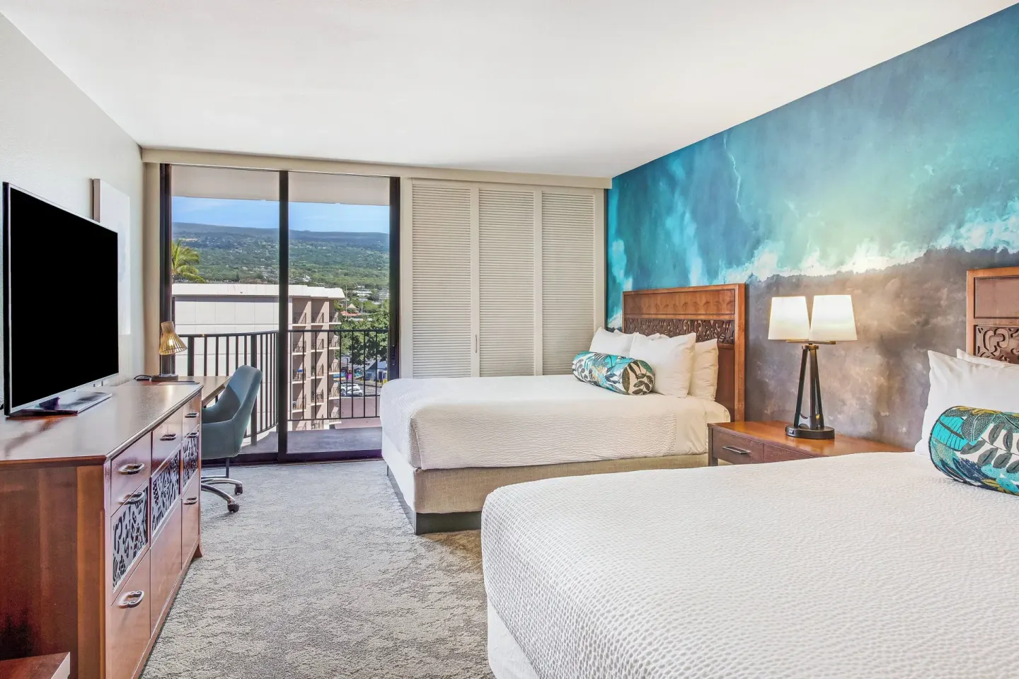 Resort view room with two beds and balcony at Courtyard King Kamehameha's Kona Beach Hotel.