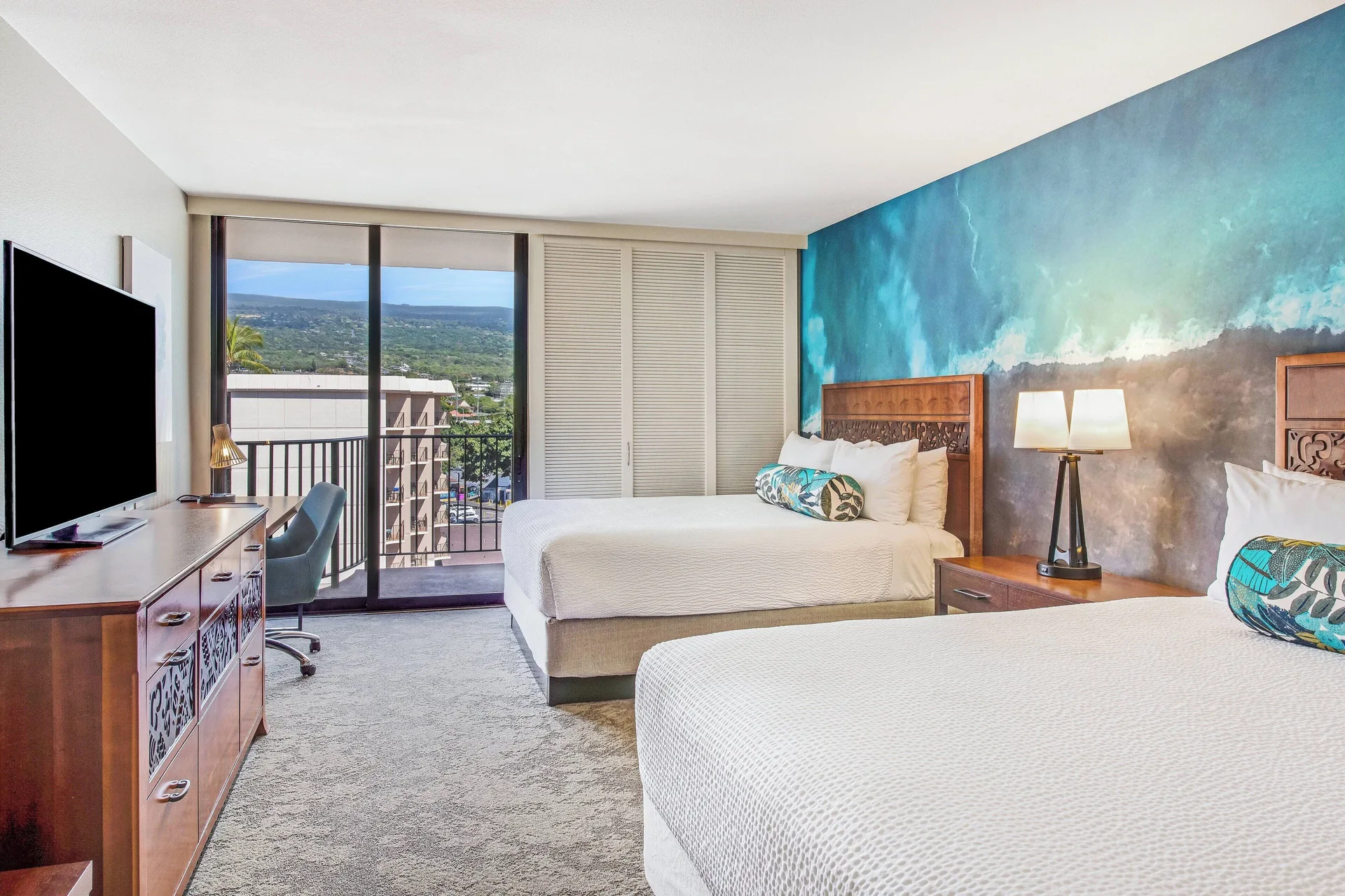 Resort view room with two beds and balcony at Courtyard King Kamehameha's Kona Beach Hotel.