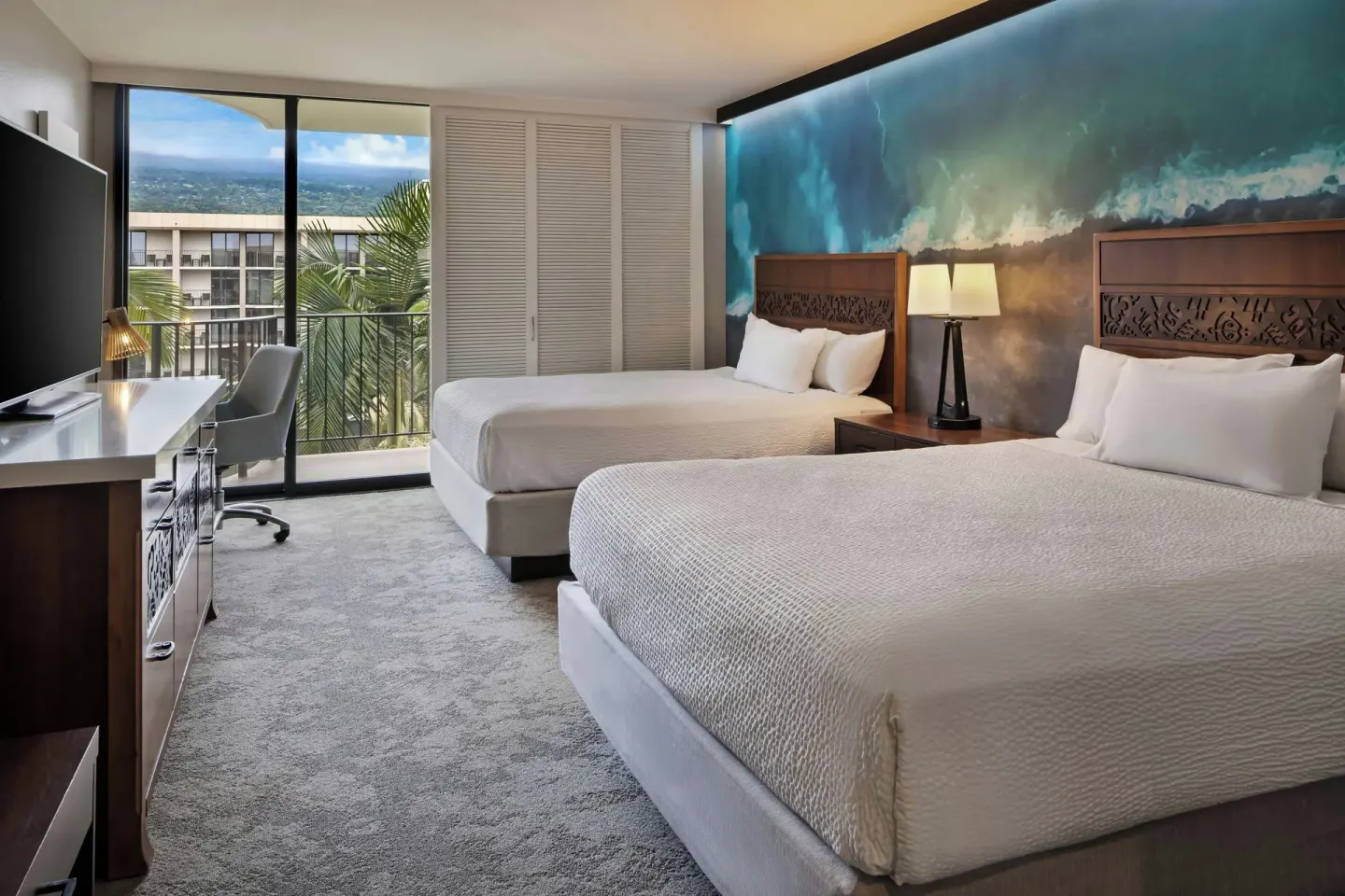 Two-bed room with balcony and resort view at Courtyard King Kamehameha's Kona Beach Hotel.