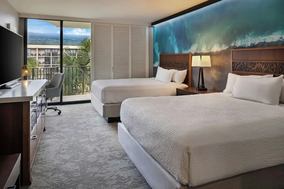 Two-bed room with balcony and resort view at Courtyard King Kamehameha's Kona Beach Hotel.