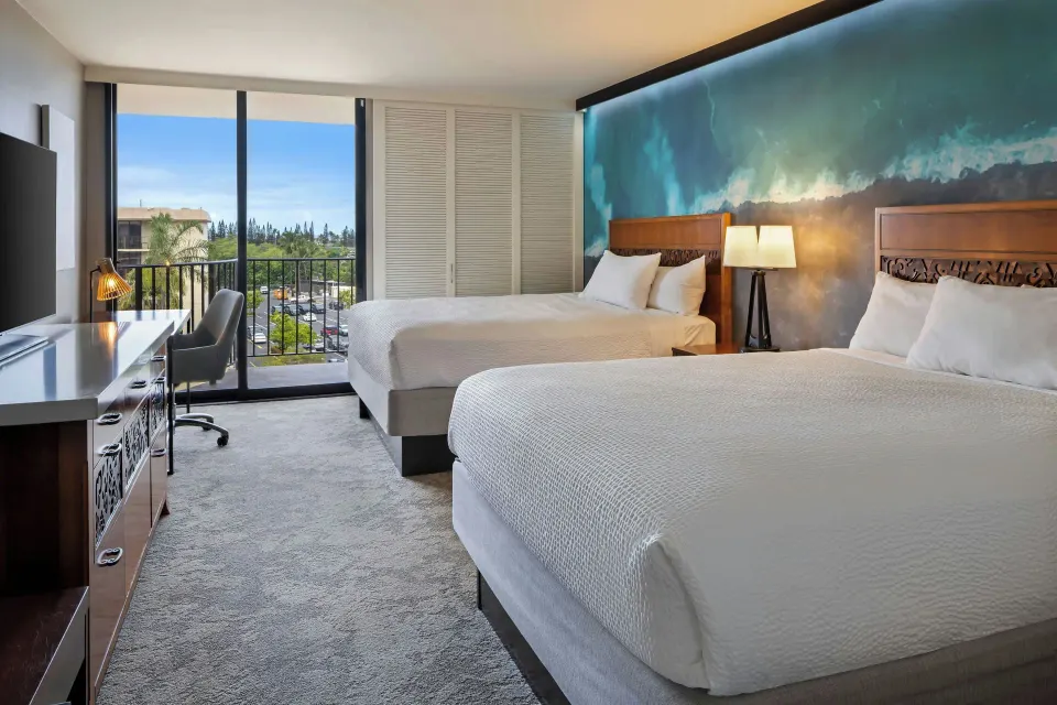 Two-bed resort view room with balcony at Courtyard King Kamehameha's Kona Beach Hotel.