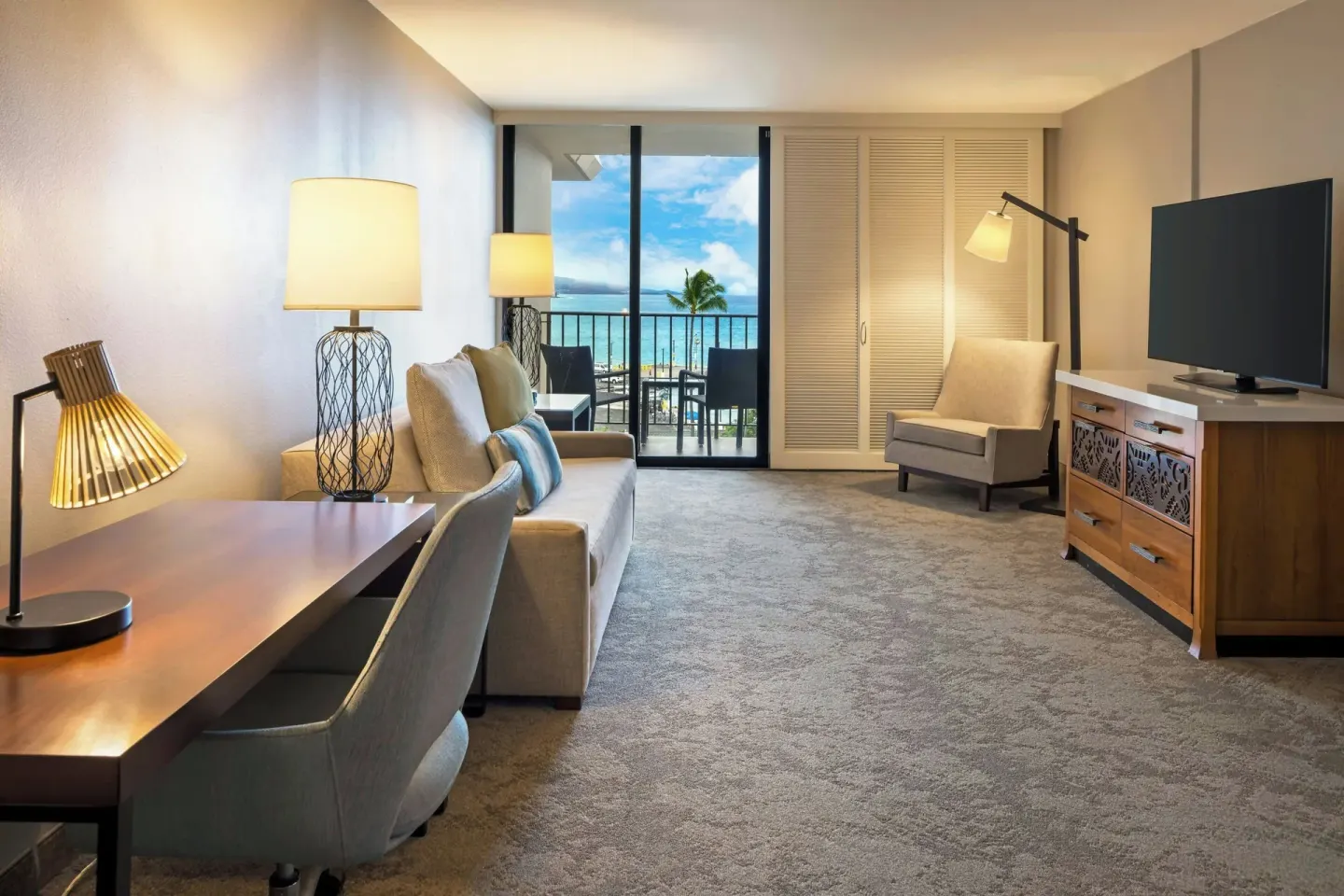 Oceanfront suite living room with desk at Courtyard King Kamehameha's Kona Beach Hotel.