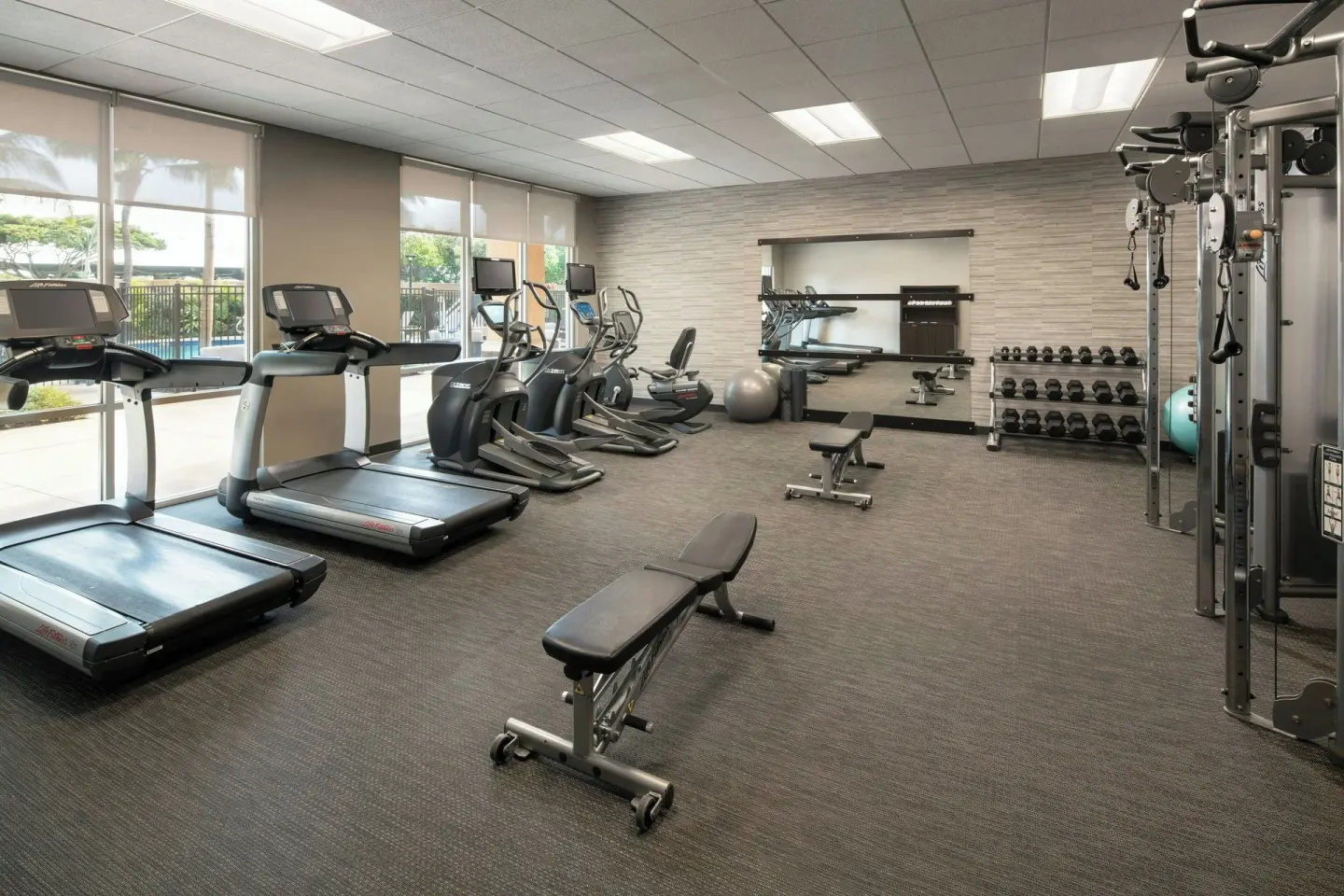 Fitness center with cardio machines and weights at Courtyard Maui Kahului Airport.