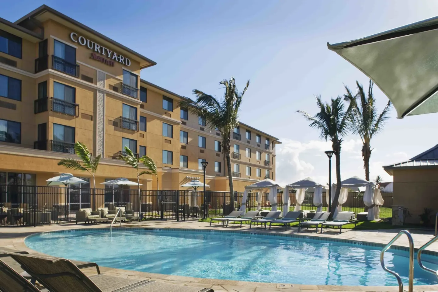 Outdoor pool beside the hotel building at Courtyard Maui Kahului Airport.
