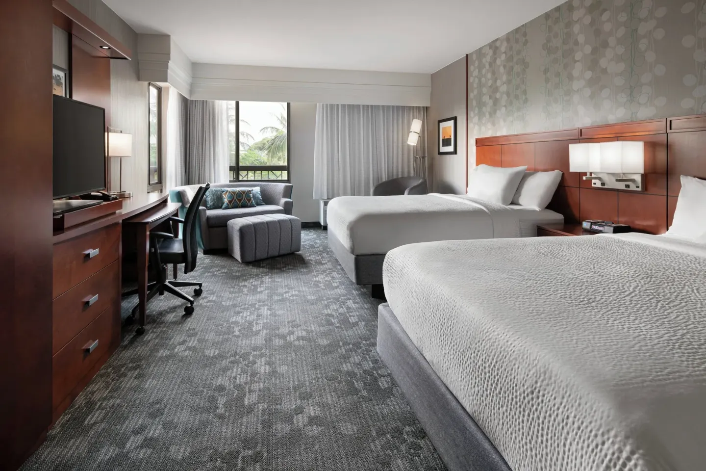 Hearing accessible room with two beds and seating at Courtyard Maui Kahului Airport.