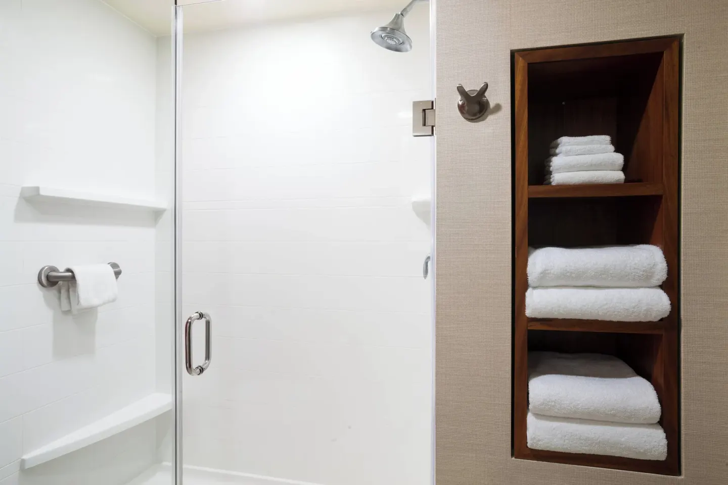 One-bedroom suite shower and towel shelves at Courtyard Maui Kahului Airport.