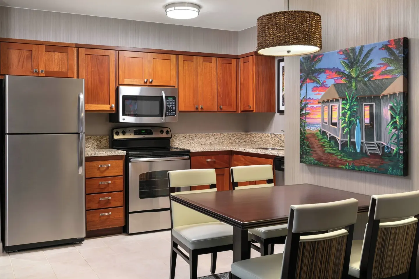 One-bedroom suite kitchen and dining area at Courtyard Maui Kahului Airport.