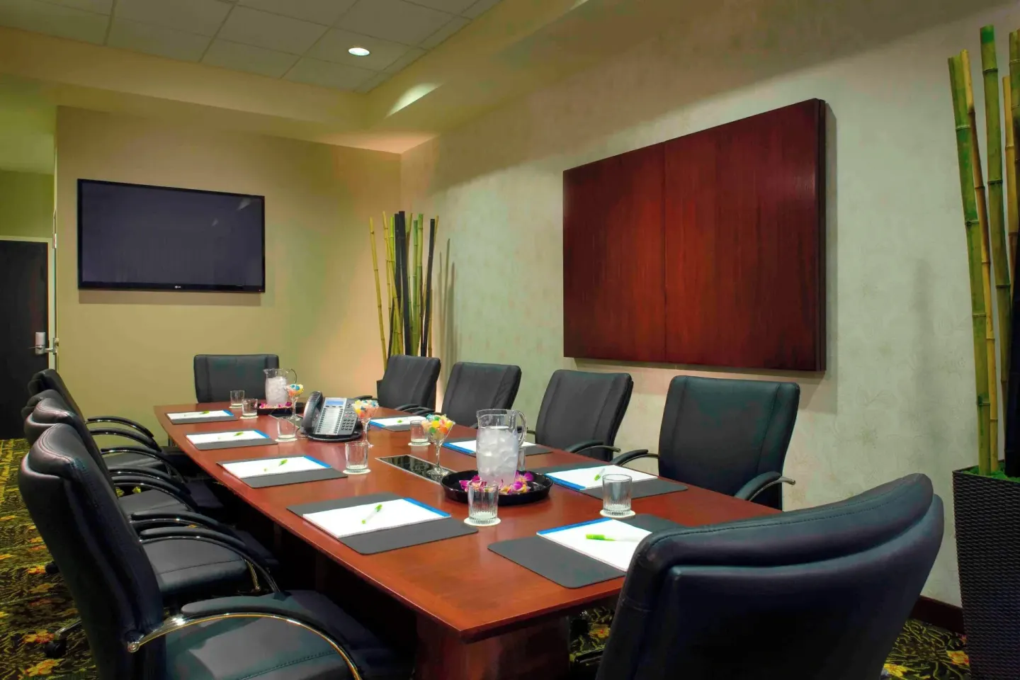 Boardroom table set with chairs, notepads and water at Courtyard Maui Kahului Airport.