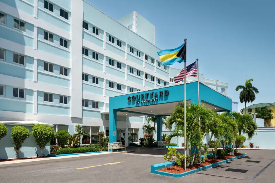 Hotel entrance with flags at Courtyard Nassau Downtown/Junkanoo Beach.