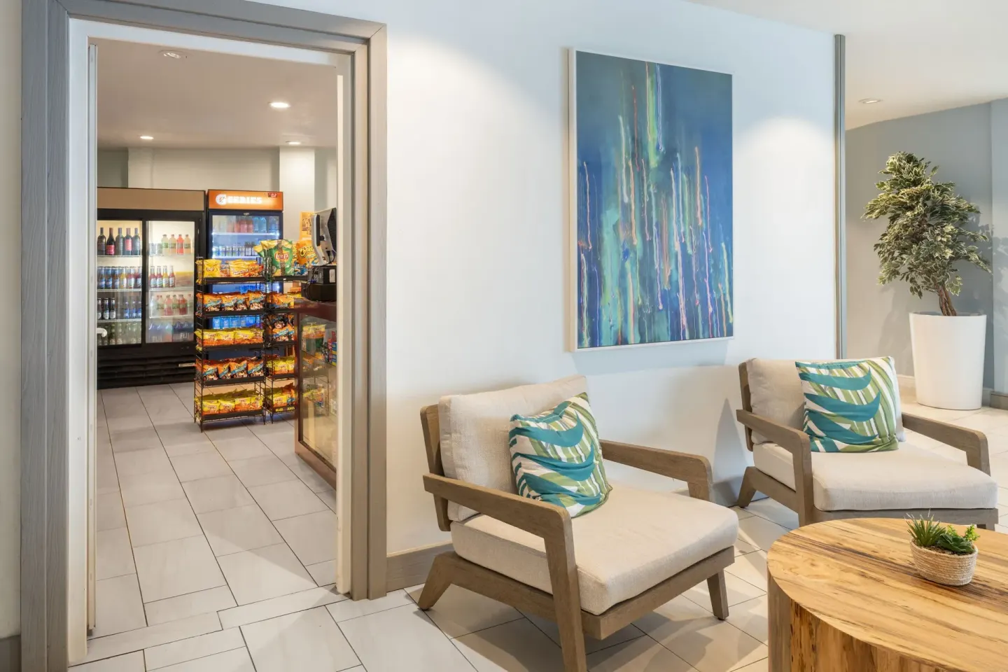 Lobby seating beside a small market at Courtyard Nassau Downtown/Junkanoo Beach.
