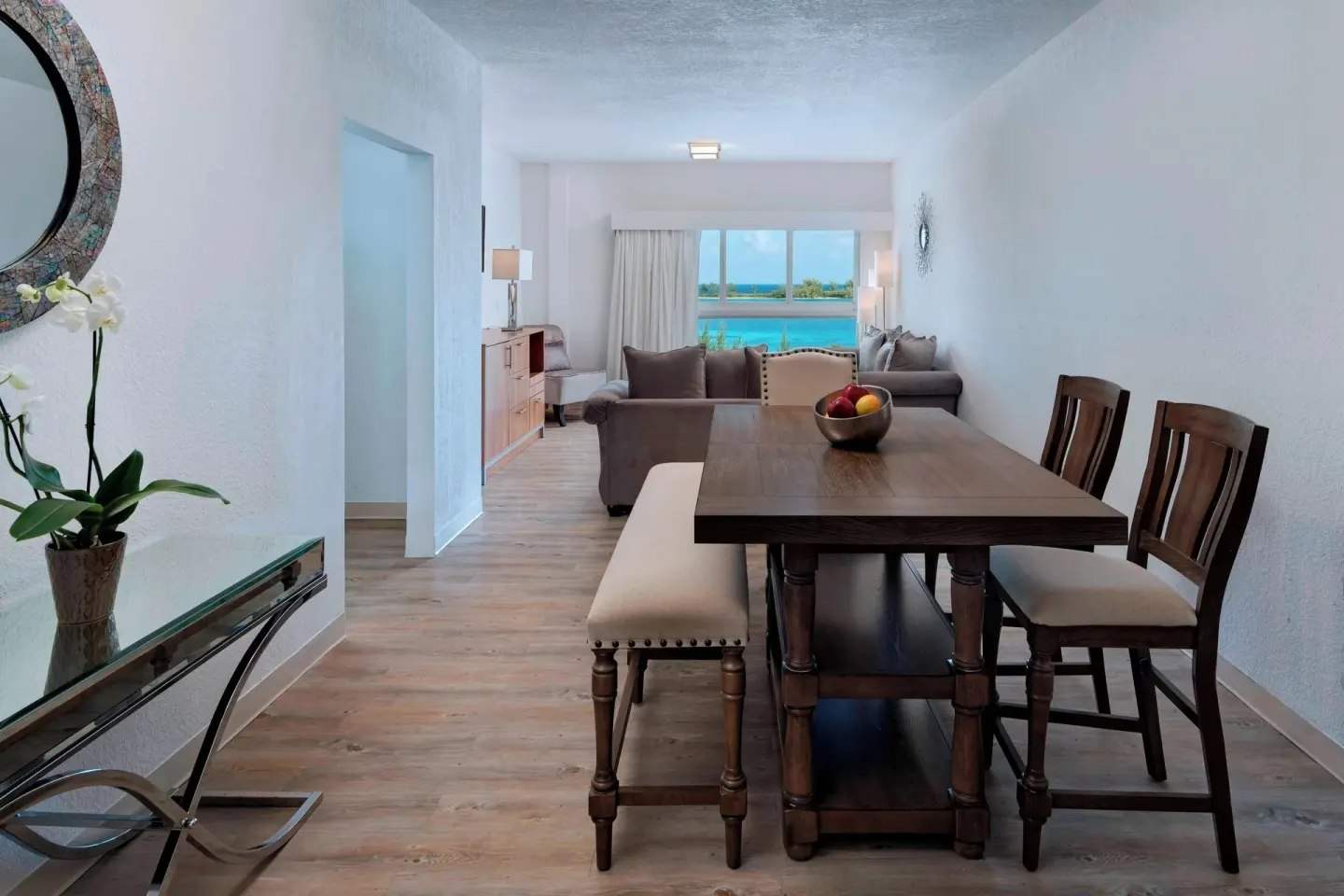 Suite dining and living area at Courtyard Nassau Downtown/Junkanoo Beach with a table and water view.