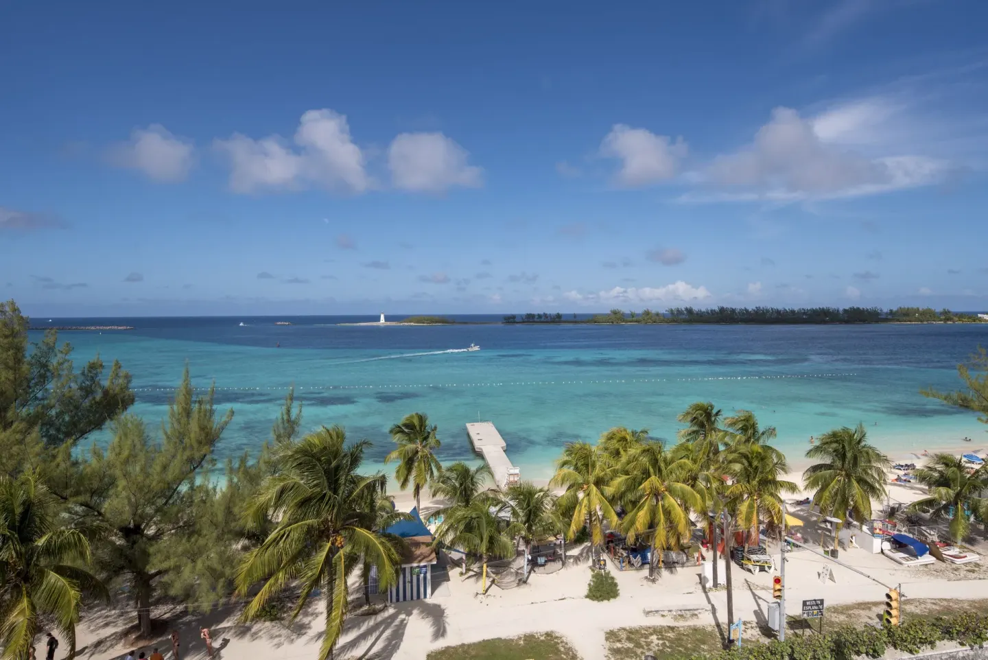 Oceanfront room view of beach, pier and blue water at Courtyard Nassau Downtown/Junkanoo Beach.