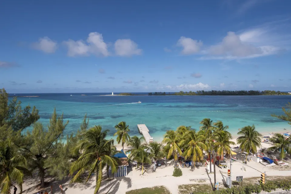 Oceanfront room view of beach, pier and blue water at Courtyard Nassau Downtown/Junkanoo Beach.