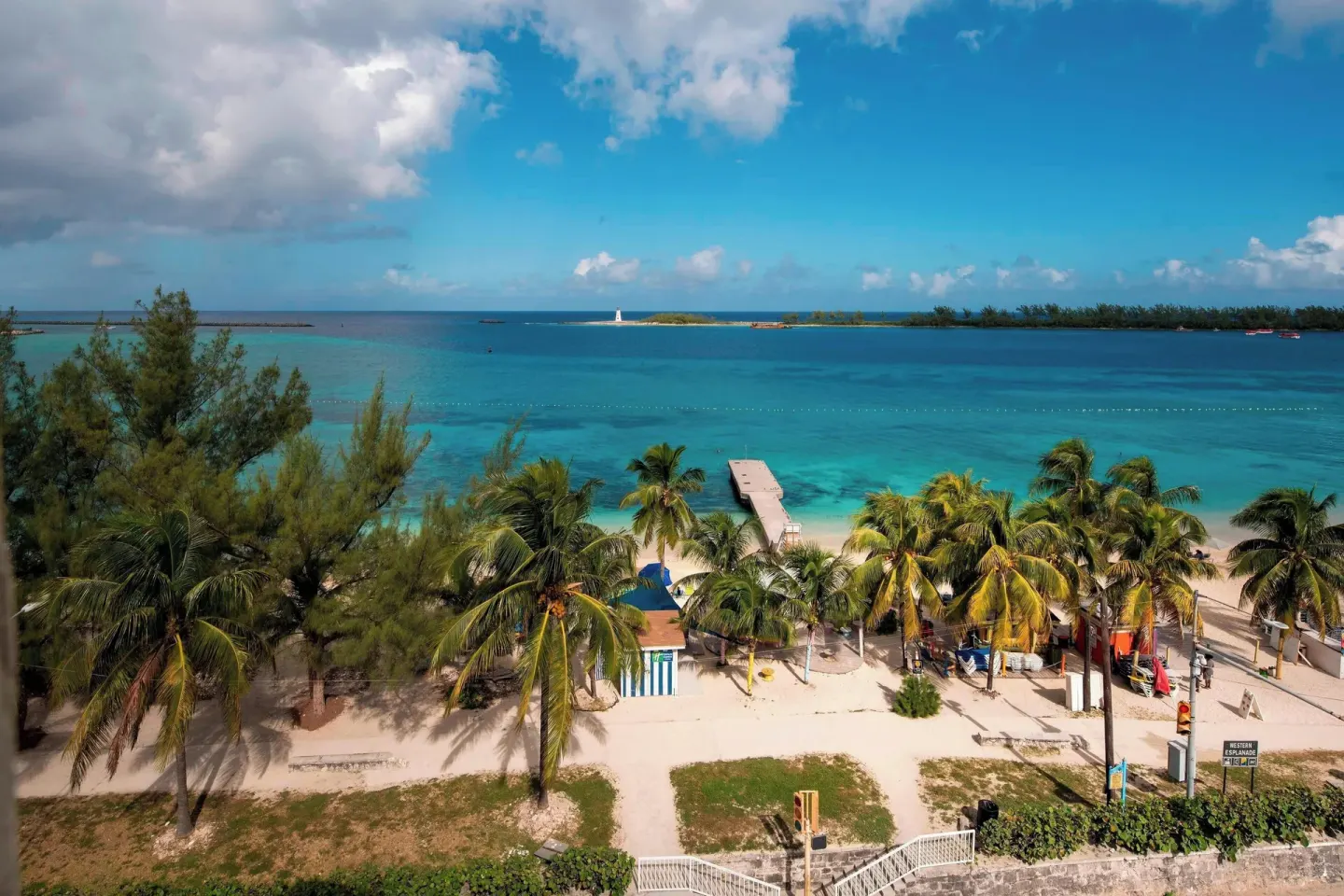 Oceanfront room view of Junkanoo Beach, palms and a pier at Courtyard Nassau Downtown/Junkanoo Beach.