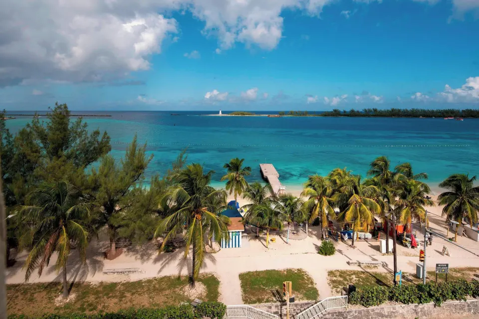 Oceanfront room view of Junkanoo Beach, palms and a pier at Courtyard Nassau Downtown/Junkanoo Beach.