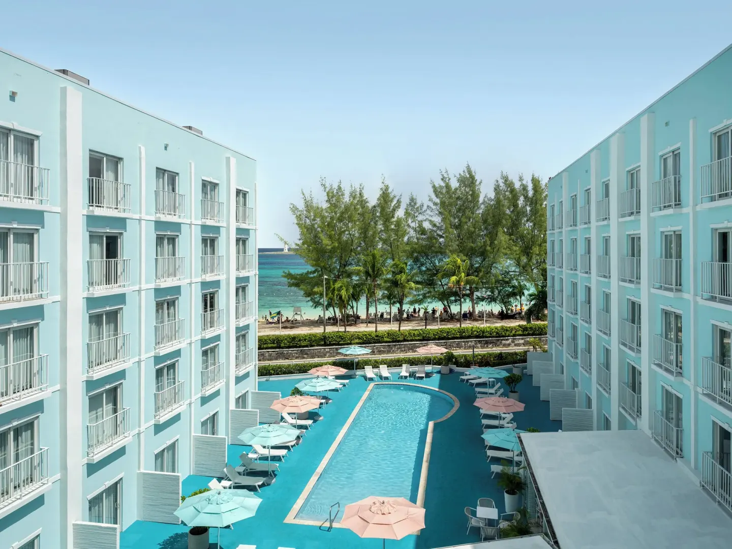 Pool courtyard and beach view between hotel buildings at Courtyard Nassau Downtown/Junkanoo Beach.