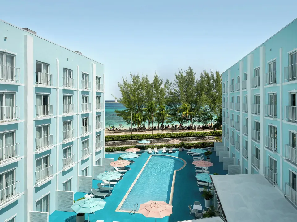 Pool courtyard and beach view between hotel buildings at Courtyard Nassau Downtown/Junkanoo Beach.