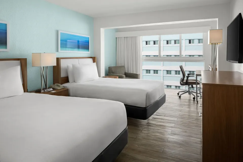 Two-bed standard room with desk and large window at Courtyard Nassau Downtown/Junkanoo Beach.