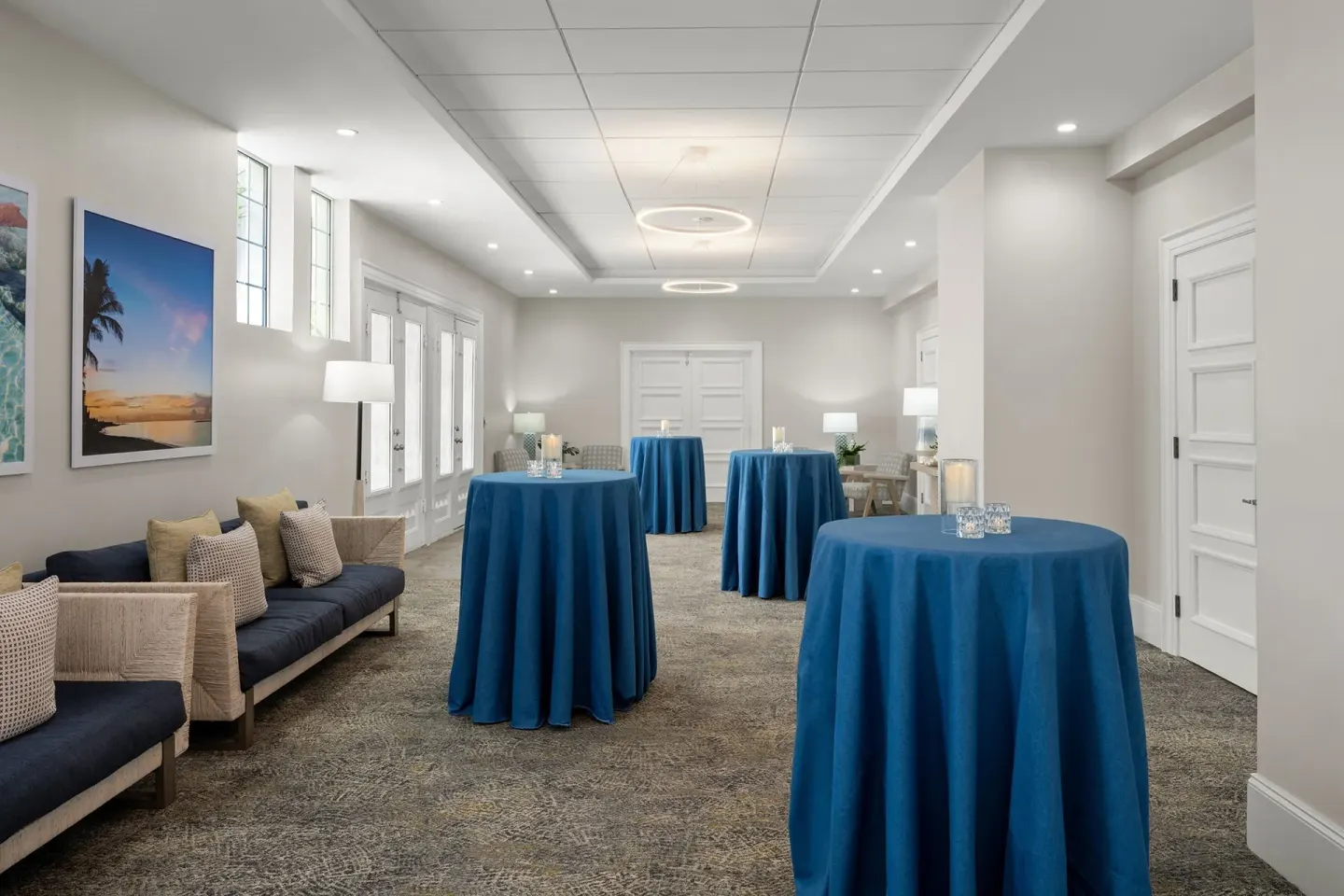 Event space at Courtyard Nassau Downtown/Junkanoo Beach set with blue cocktail tables and lounge seating.