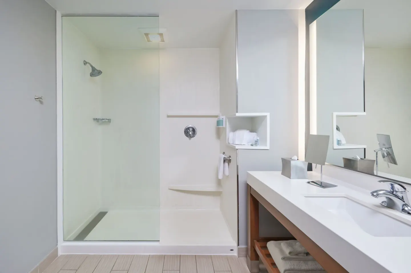 Guest bathroom with glass shower and long vanity at Courtyard Oahu North Shore.