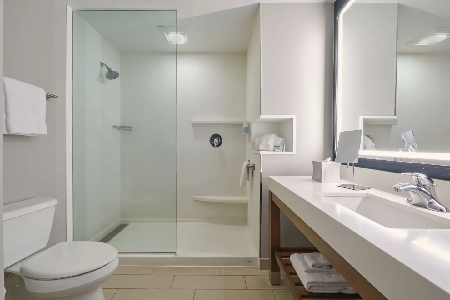 Guest bathroom with toilet, shower, and vanity at Courtyard Oahu North Shore.