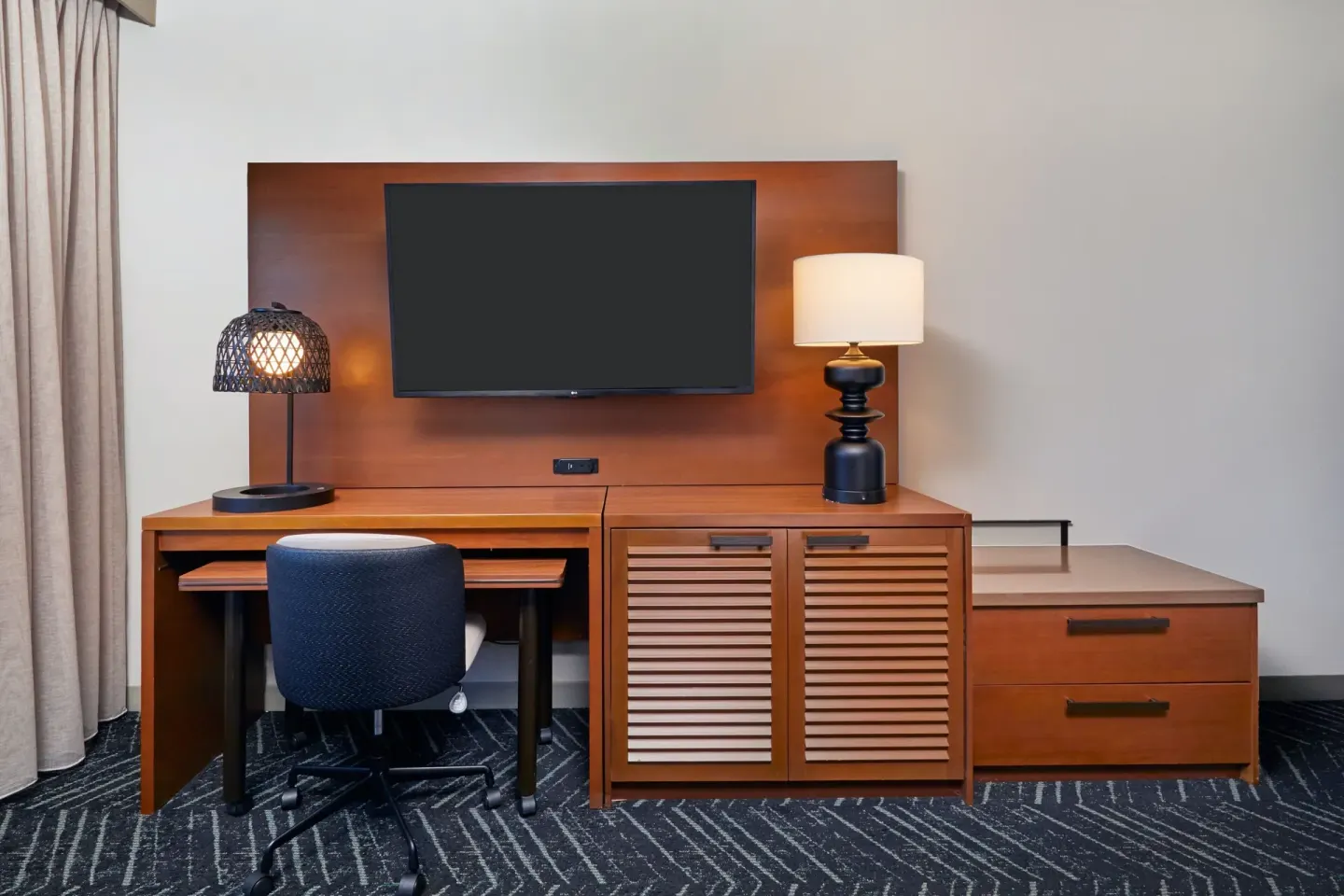 Guest room desk and TV wall at Courtyard Oahu North Shore.