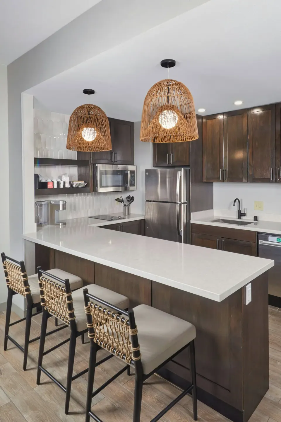 Suite kitchen with island seating at Courtyard Oahu North Shore.