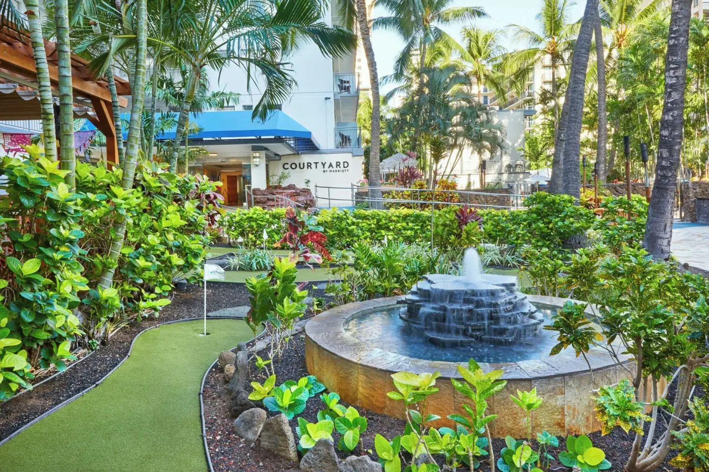 Garden putting green and fountain at Courtyard Waikiki Beach.