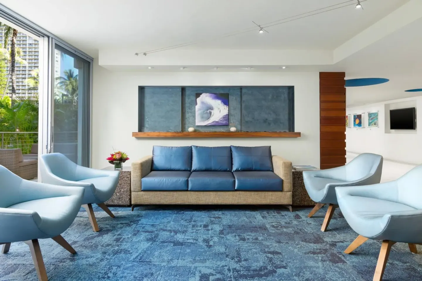 Blue lounge seating area in the lobby at Courtyard Waikiki Beach.