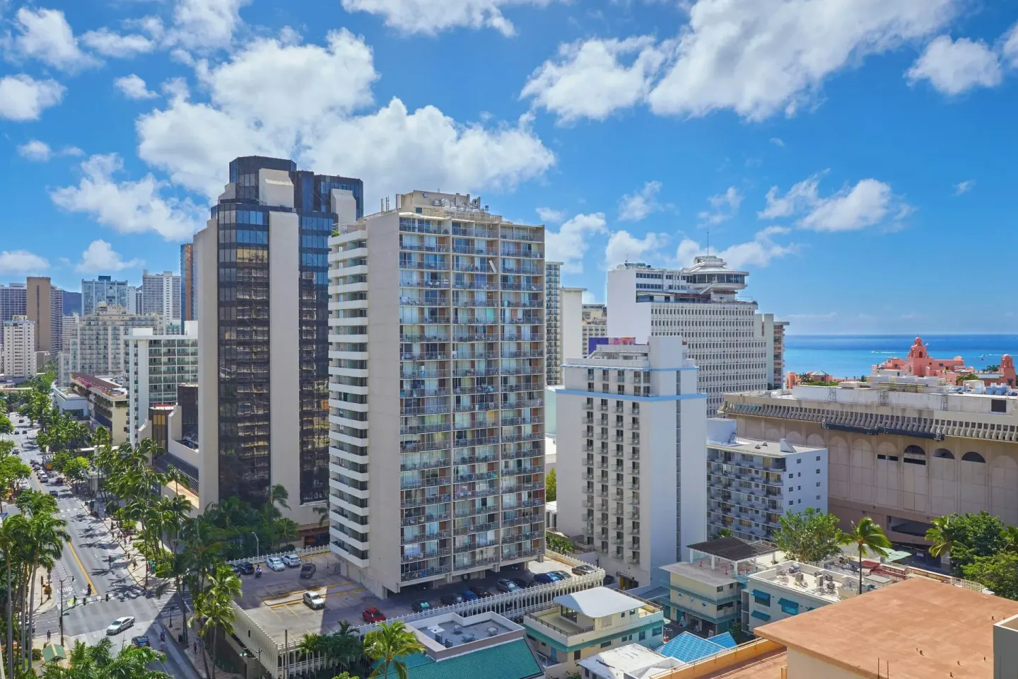 Waikiki city buildings and a glimpse of ocean near Courtyard Waikiki Beach.