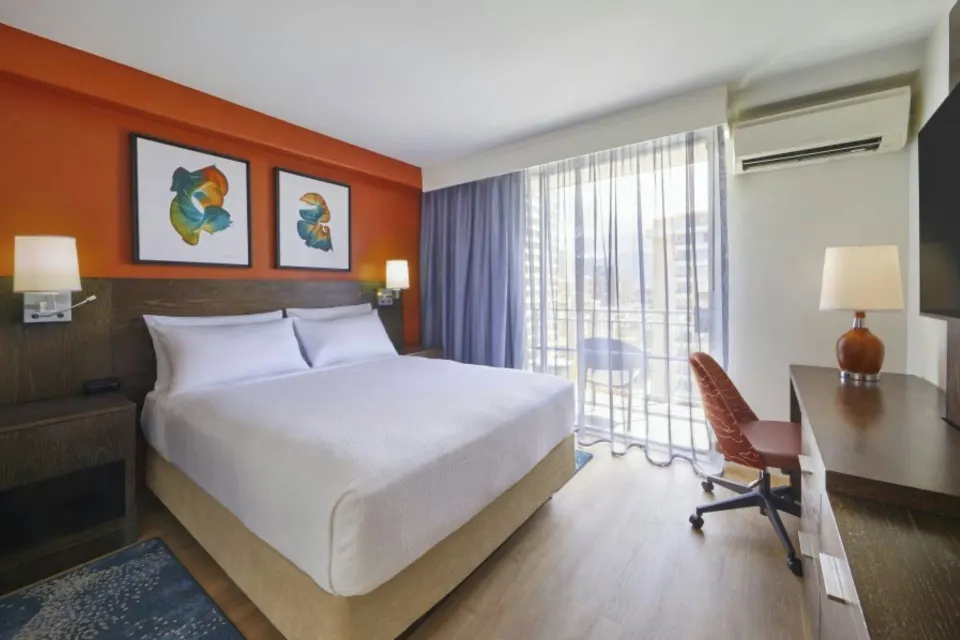 Standard Studio king bed with balcony light at Courtyard Waikiki Beach.