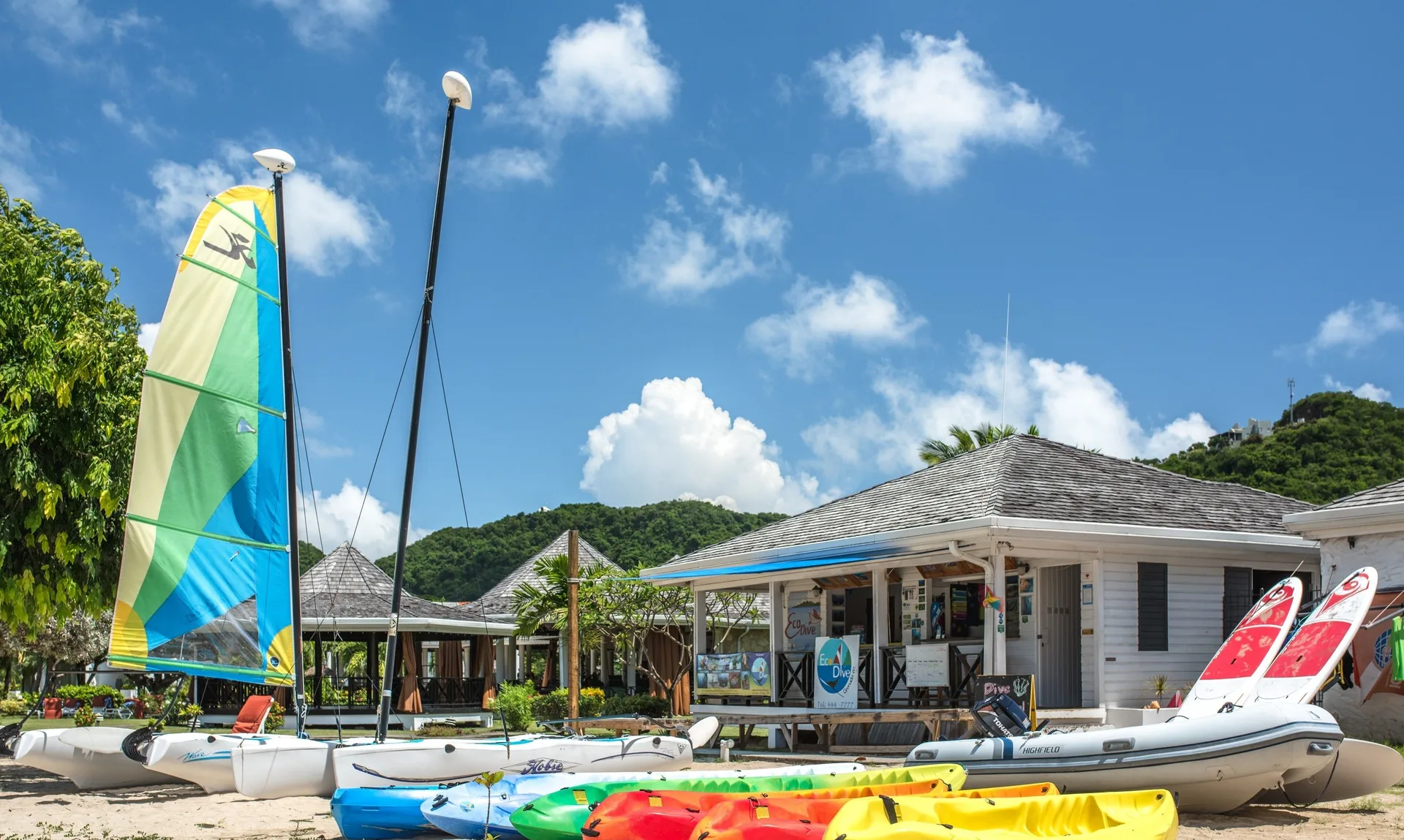 Watersports boats and kayaks on the beach at Coyaba Beach Resort.