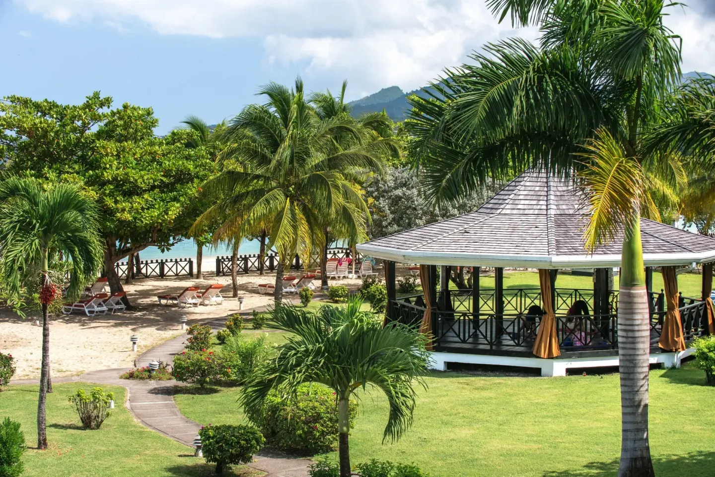 Garden gazebo near the beach and palms at Coyaba Beach Resort.