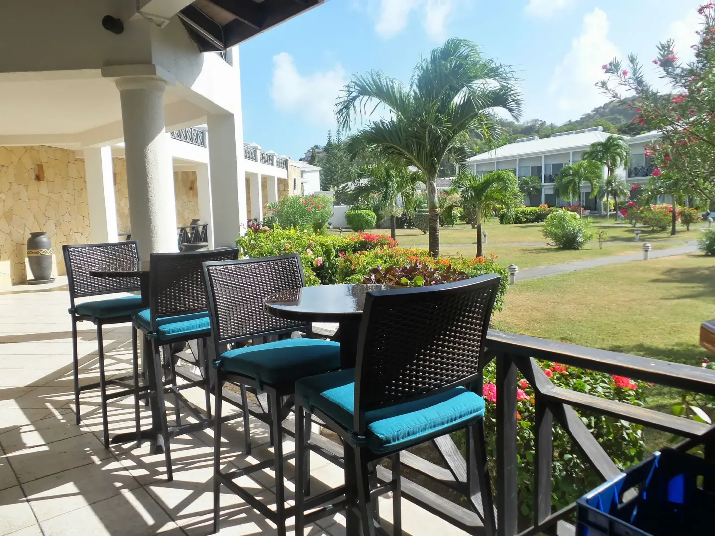 Covered terrace seating overlooking gardens at Coyaba Beach Resort.