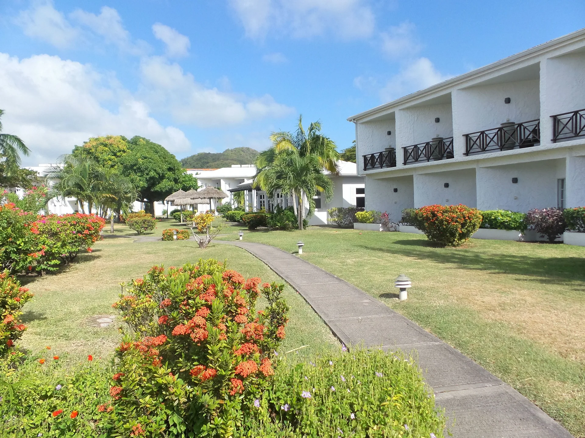 Guest building beside lawns and flowering gardens at Coyaba Beach Resort.
