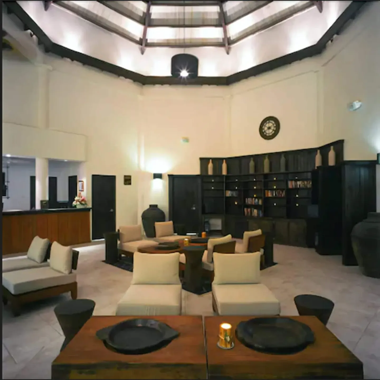 Lobby lounge with sofas, tables and a high ceiling at Coyaba Beach Resort.