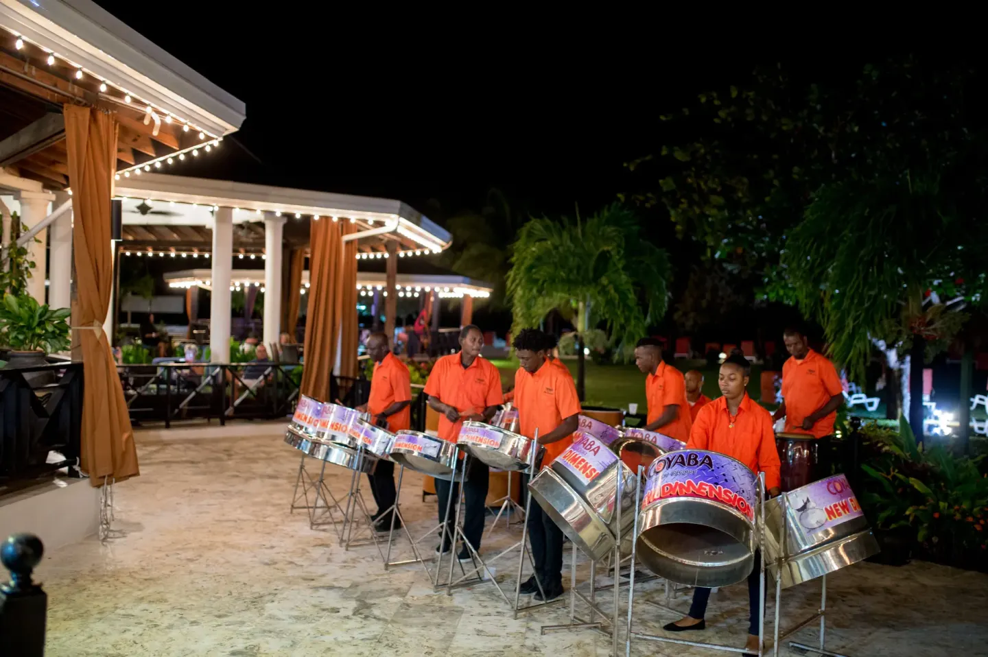 Steel pan band performing outdoors at night at Coyaba Beach Resort.
