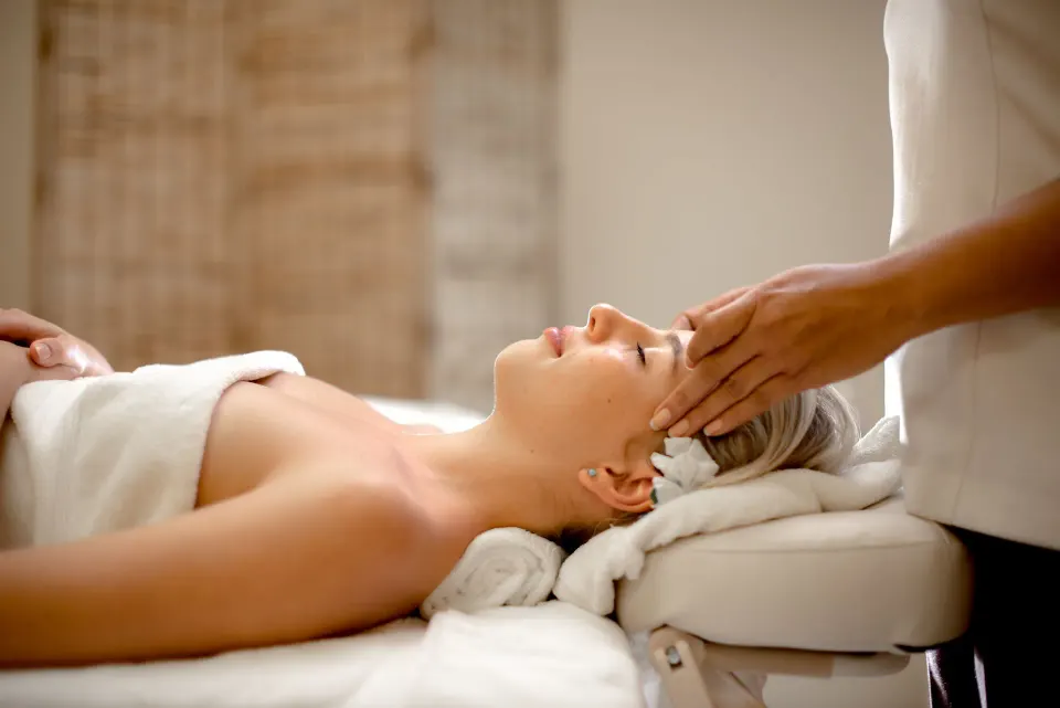 Guest receiving a head massage on a spa table at Coyaba Beach Resort.