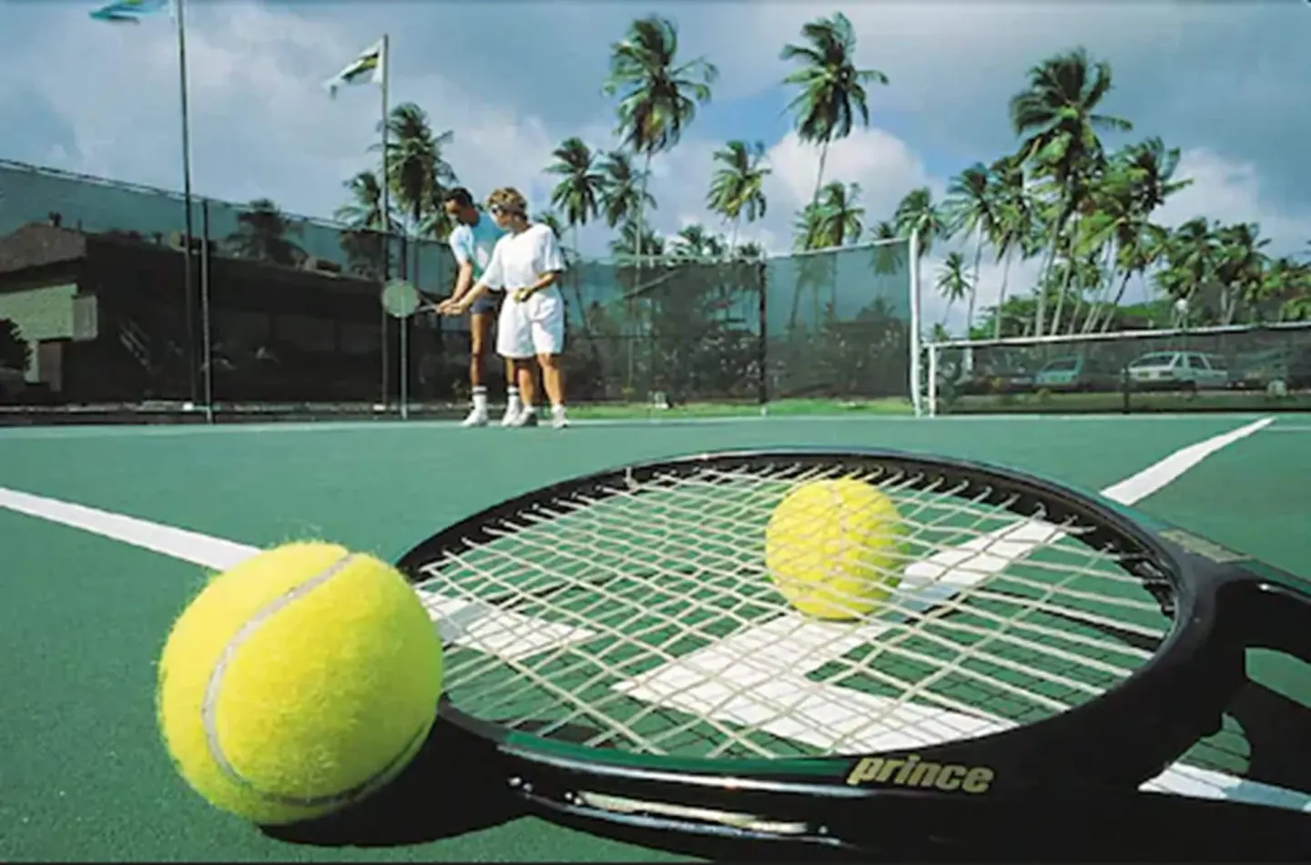 Tennis racket and balls on a court at Coyaba Beach Resort.