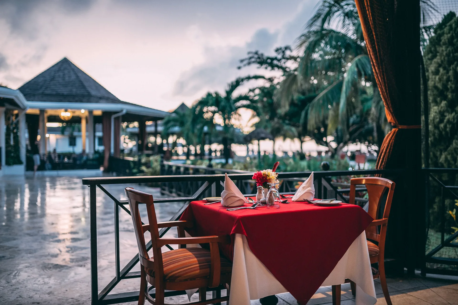 Terrace table set for two at Coyaba Beach Resort at dusk.