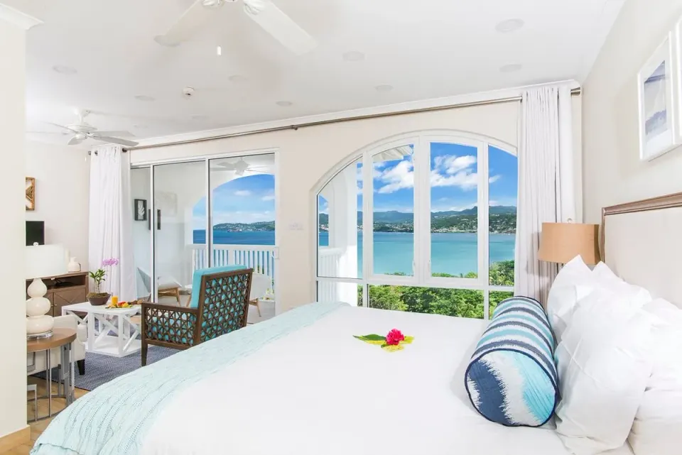 Superior Garden View room with bed, sitting area, balcony, and water view at Coyaba Beach Resort.