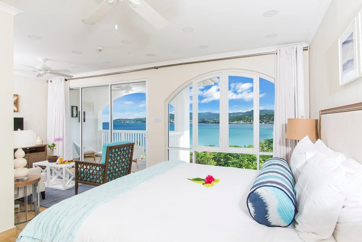 Superior Garden View room with bed, sitting area, balcony, and water view at Coyaba Beach Resort.