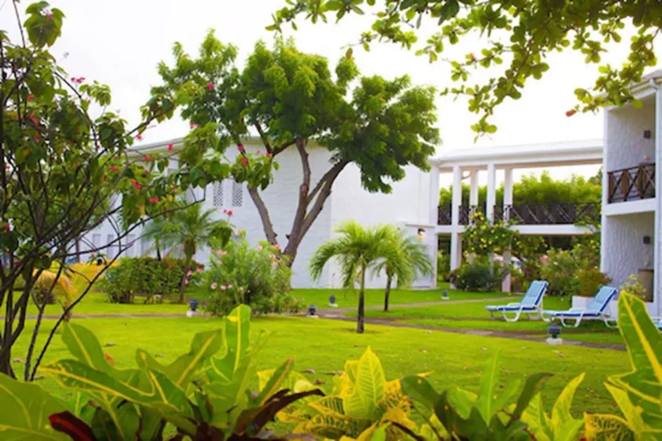 Superior Room garden view with lawns, palms and guest-room balconies at Coyaba Beach Resort.