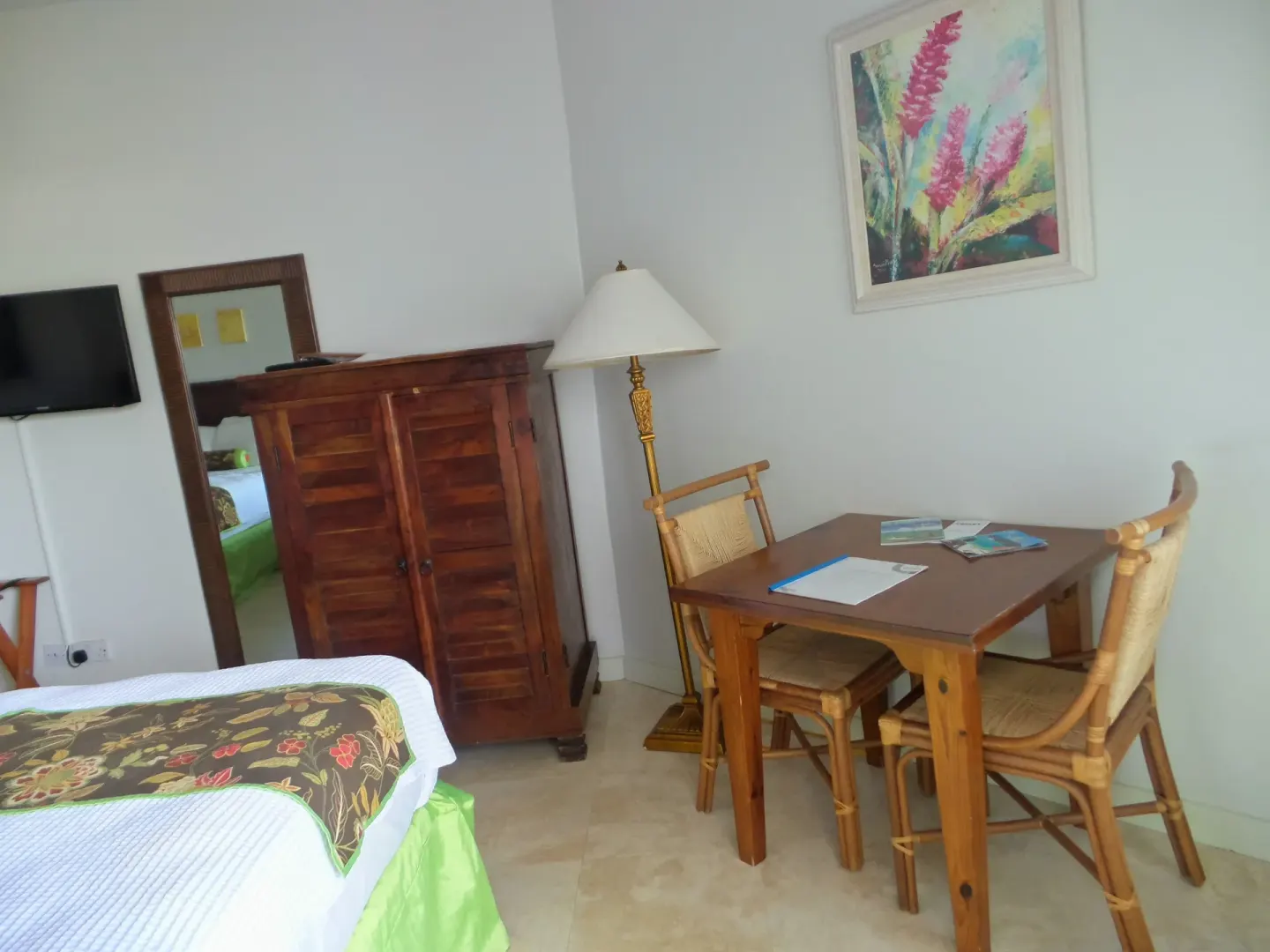 Superior Room with bed, wardrobe, and dining table at Coyaba Beach Resort.