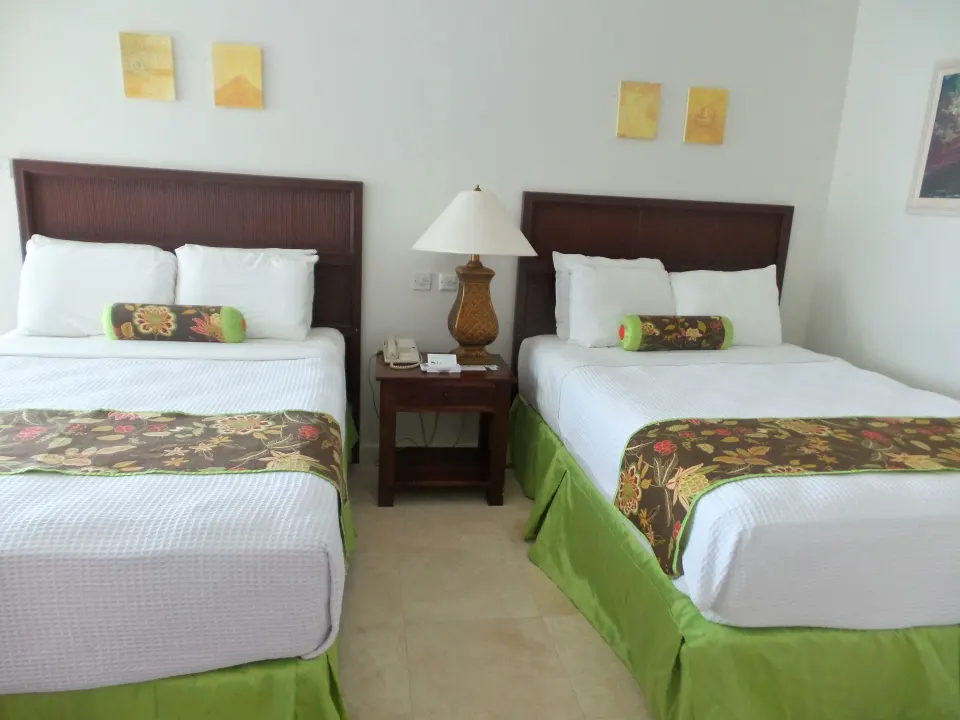 Superior Room with two double beds and a shared nightstand at Coyaba Beach Resort.